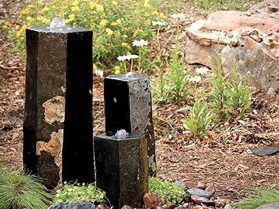 Stone water fountains in garden landscape