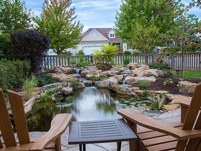 Backyard pond with rocks and garden view