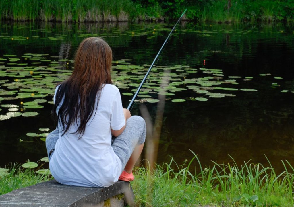 Girl fishing in pond