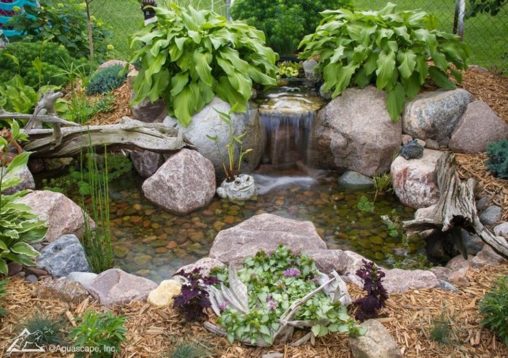 Garden pond with waterfall and rocks.