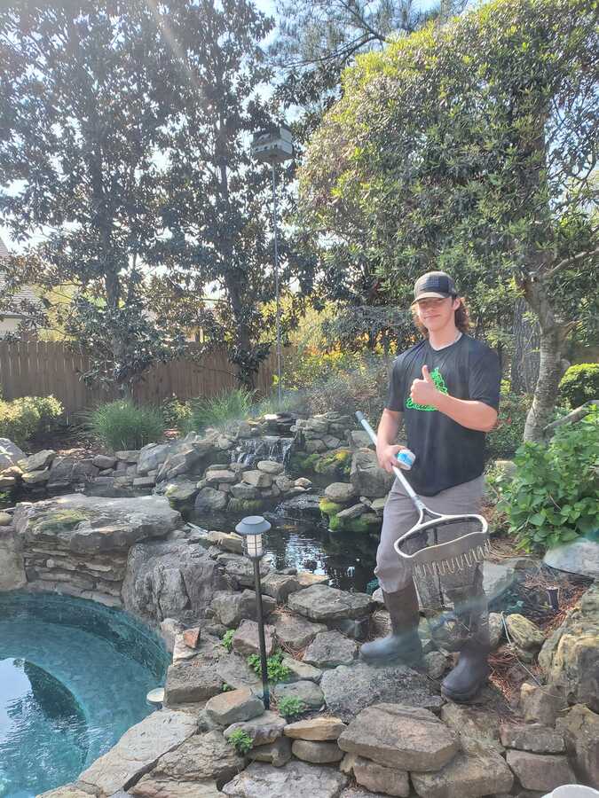 Removing debris from pond with net