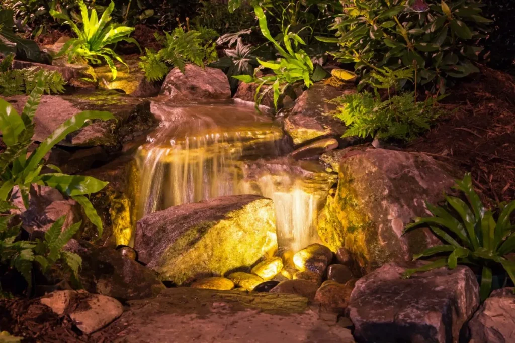 Small waterfall lit up at night