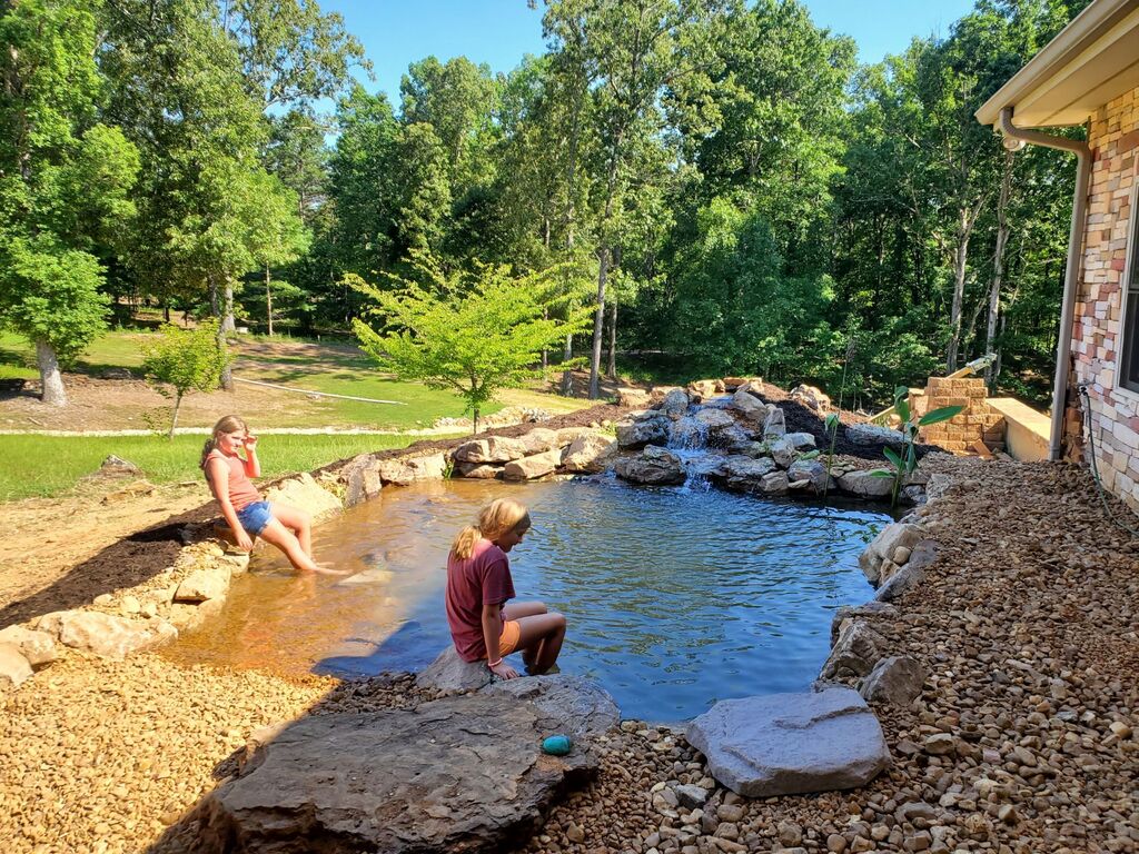 two young girls enjoying a natural swimming pool